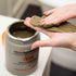 Scooping GUAM infrared seaweed mud body wrap out of the jar