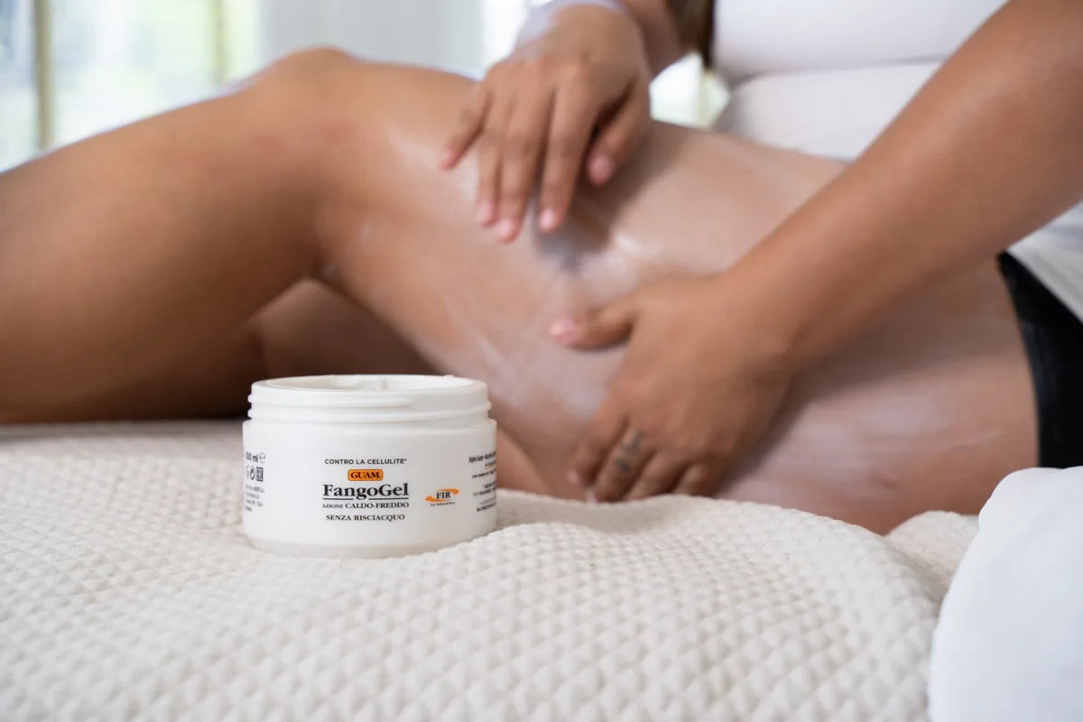 Hands massaging GUAM cellulite cream into the thigh, the best cellulite cream for thighs in use