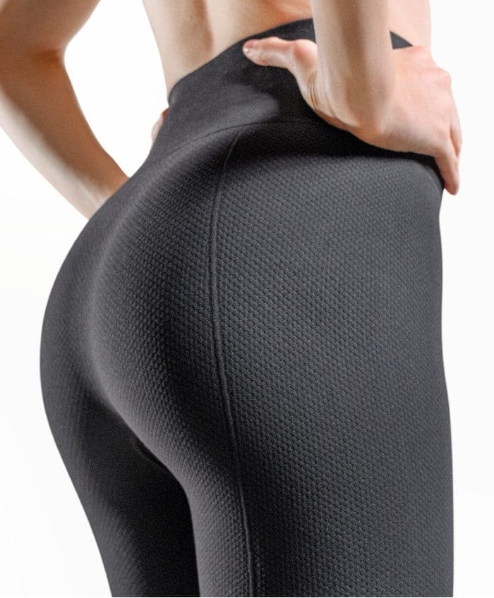 Side view of GUAM Vital Massage compression leggings for cellulite shaping the buttocks